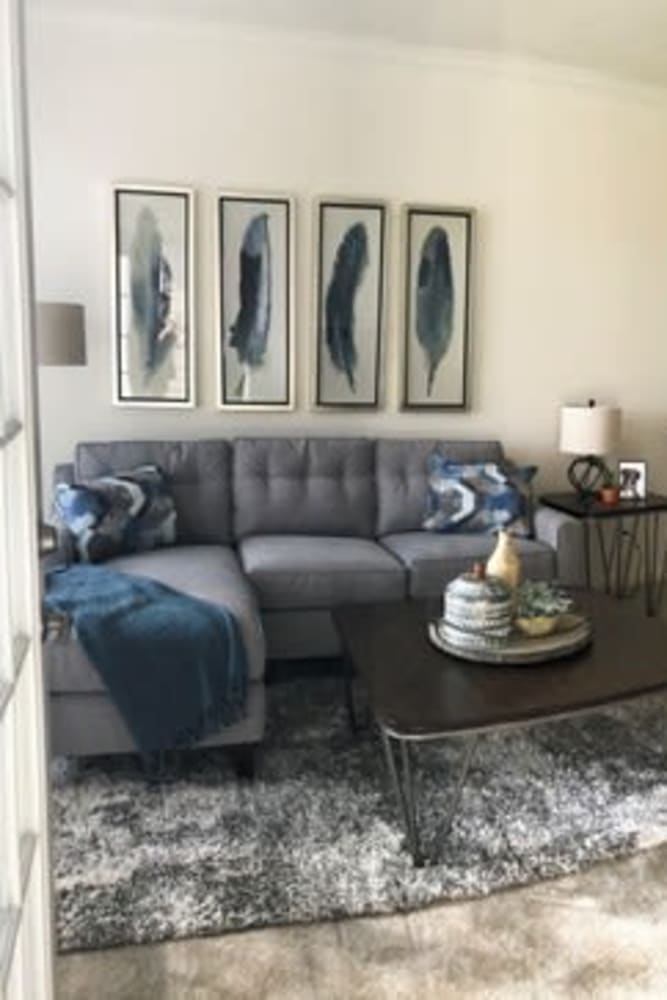 Living room with cozy sofa and other furnishings at Lakeshore Apartment Homes in Evansville, Indiana