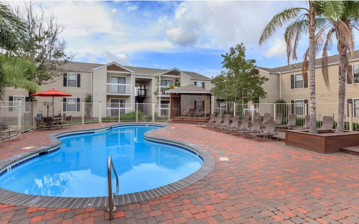 Building exterior and the swimming pool at Baywood Apartments in Gretna, Louisiana