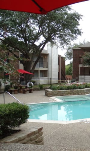 Swimming pool and sundeck patio tables at Willow Glen in Fort Worth, Texas