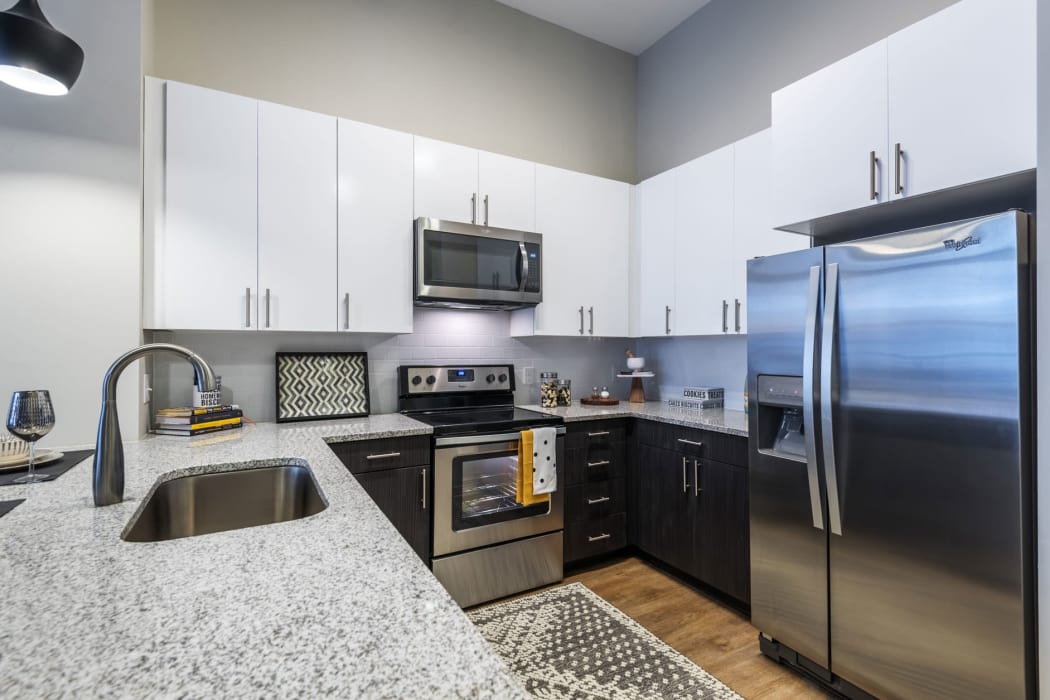 Island and stainless-steel fridge featured in the kitchen at 616 at The Village in Raleigh, North Carolina