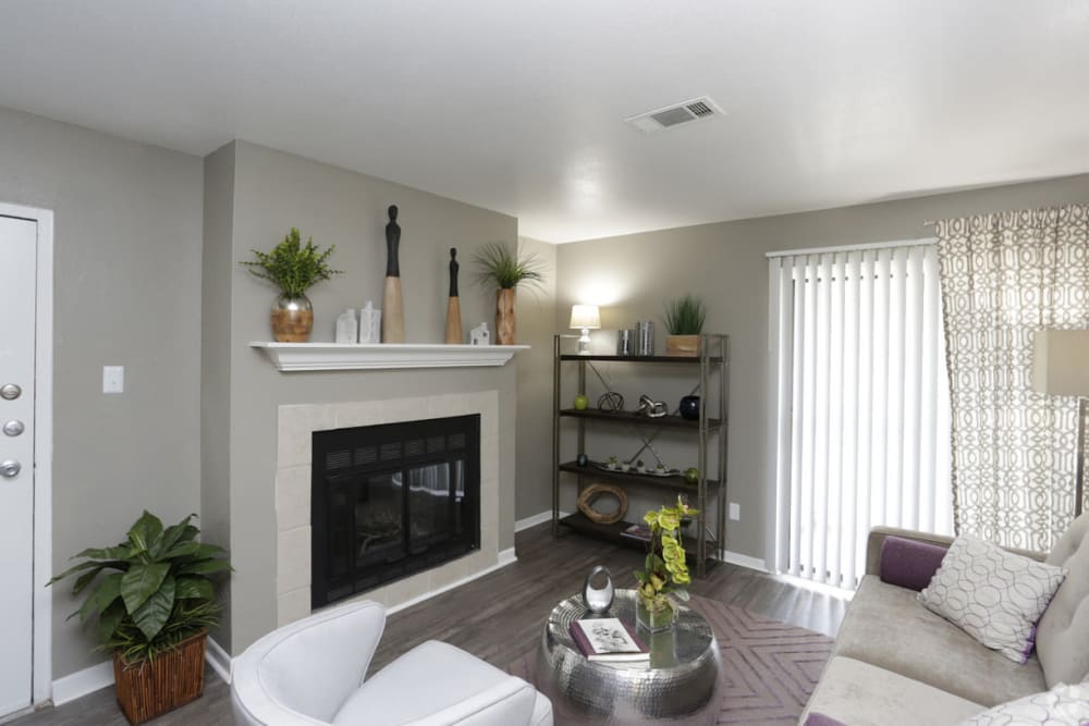 Model living room with fireplace at EnVue Apartments in Bryan, Texas