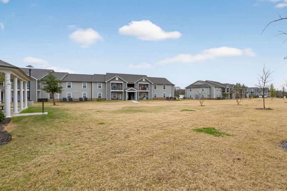 Spacious green lawns and charming apartments at Lakewood Crossing in Granbury, Texas.