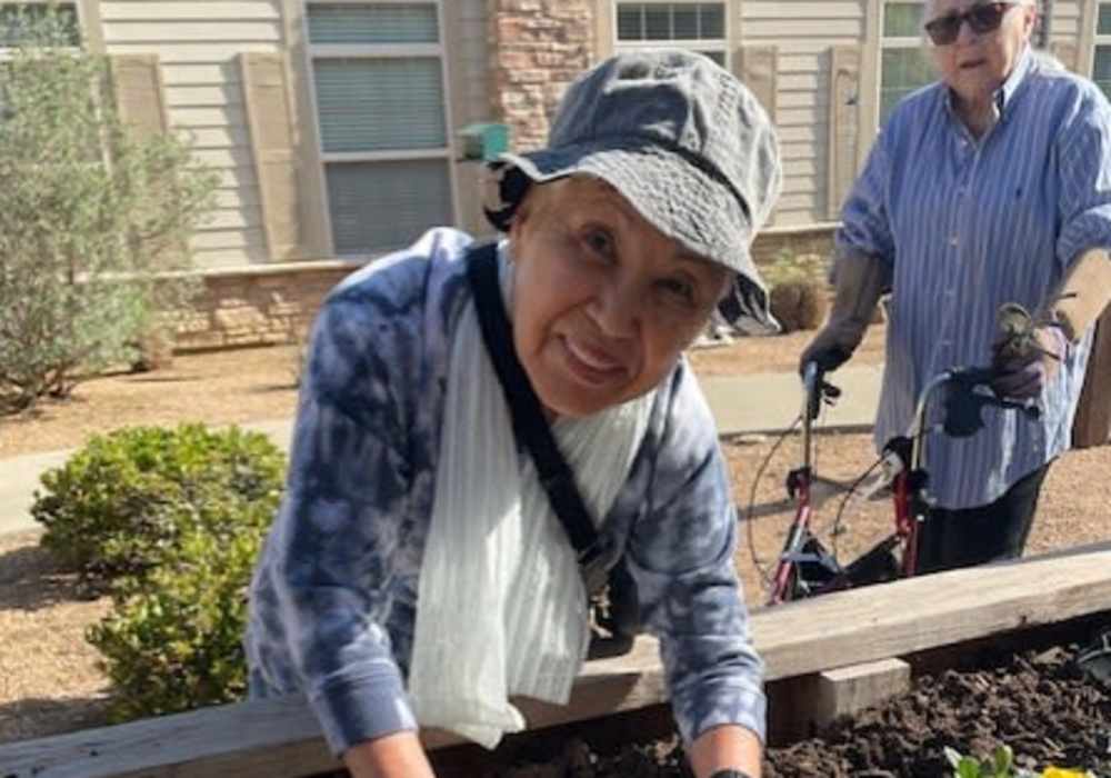 Resident enjoying gardening at Truewood by Merrill, Keller in Keller, Texas