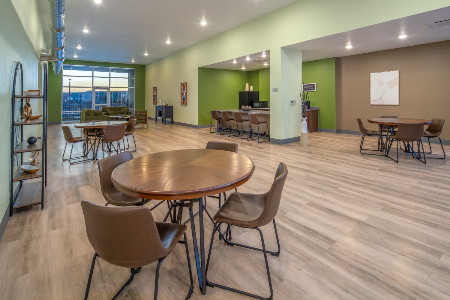 Clubhouse lounge area with tables and chairs at Casa de Encantada Senior Apartments in Rio Rancho, New Mexico
