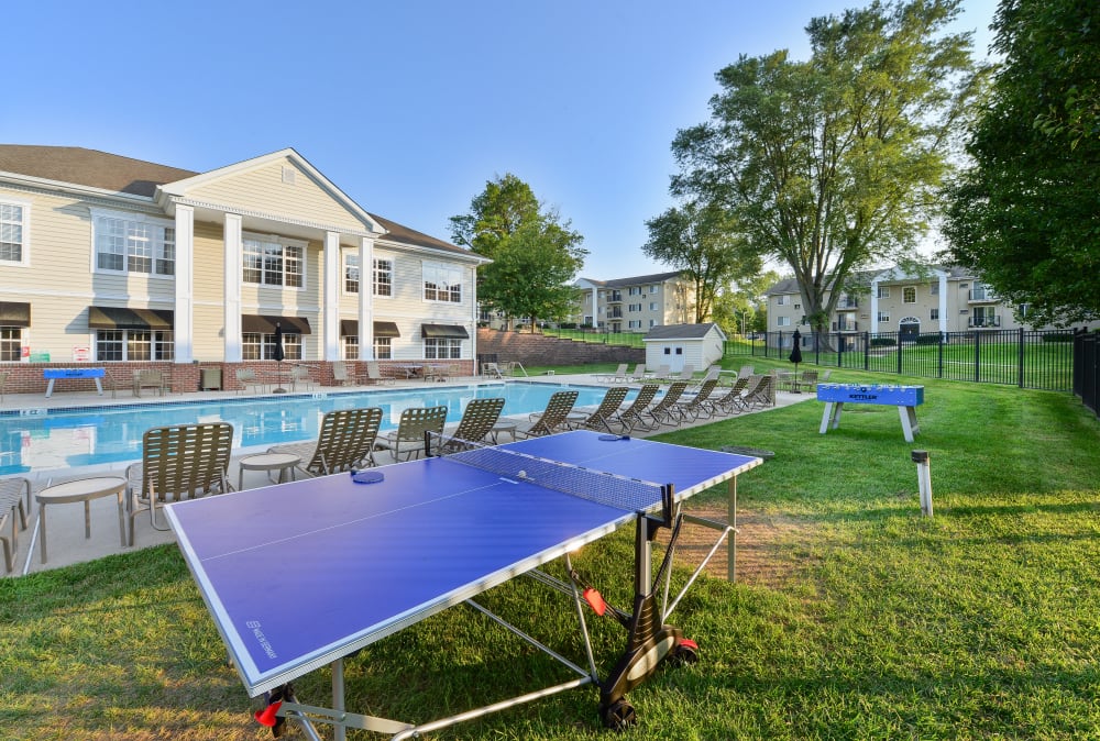Ping pong table and foosball by the swimming pool at Stonegate at Devon Apartments in Devon, Pennsylvania