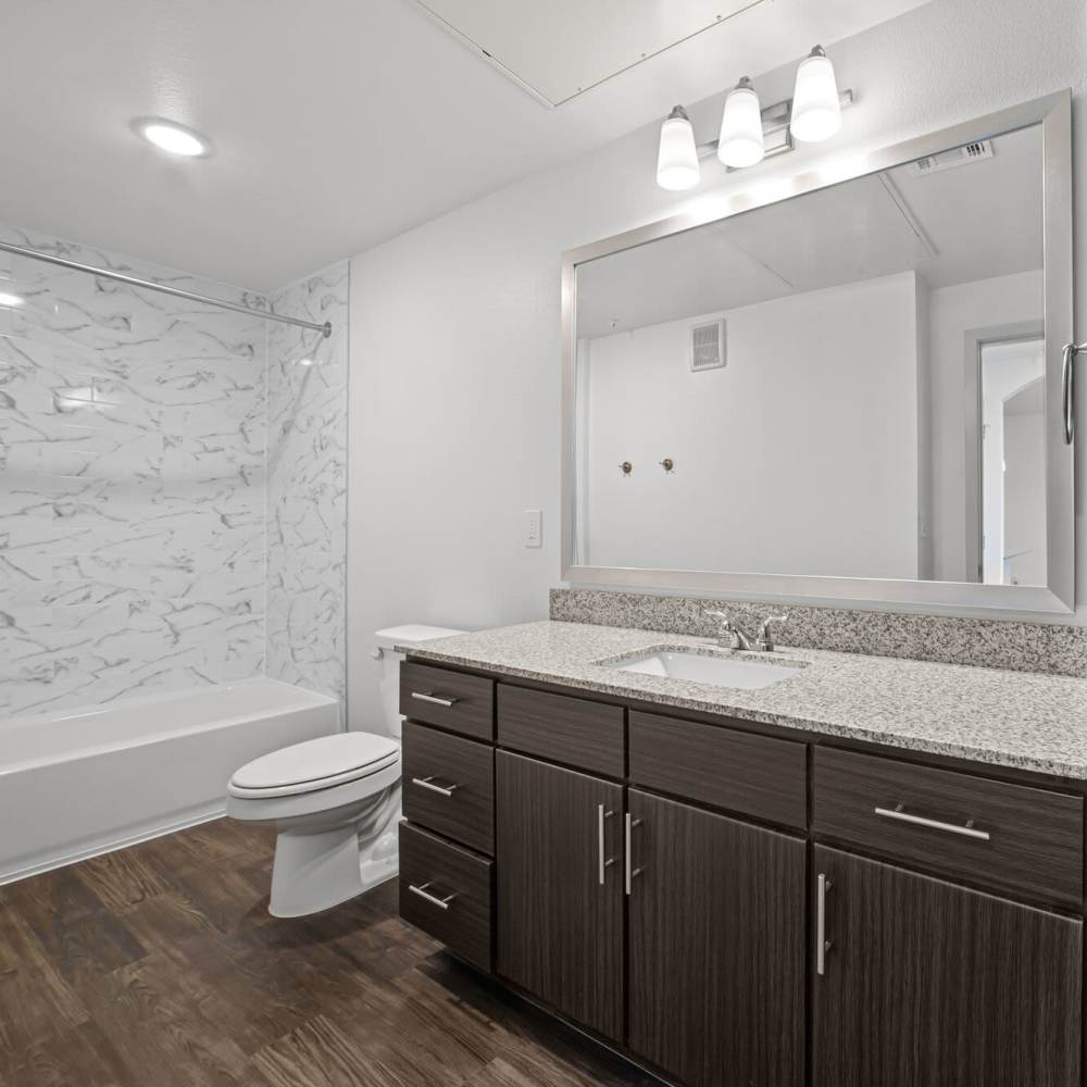 Bright bathroom with large mirror at Brook Hollow in Wichita Falls, Texas
