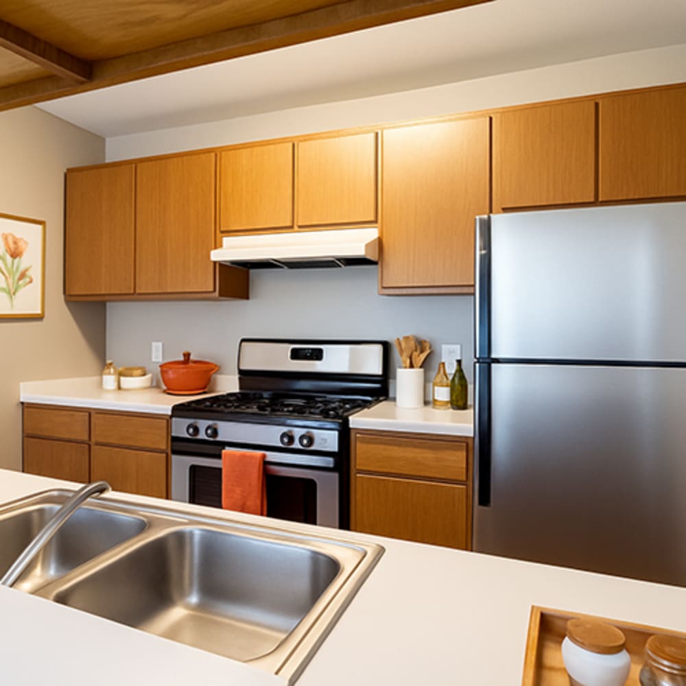 Kitchen with wooden cabinetry at Central Park Place in Grand Rapids, Michigan