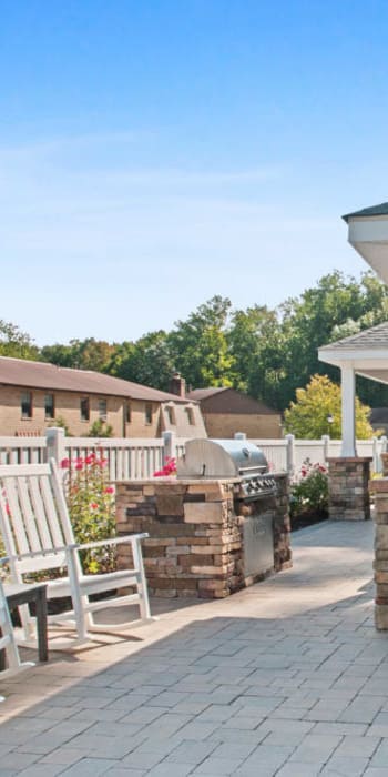 Outdoor seating with bbq grill at Timber Ridge in Lindenwold, New Jersey