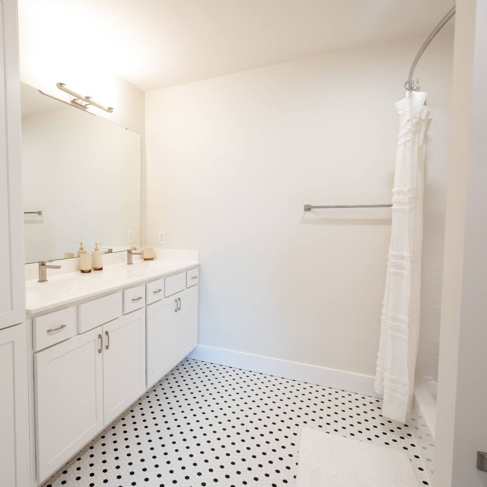 Bathroom with large mirror and vanity unit at The Cove in Port St Lucie, Florida