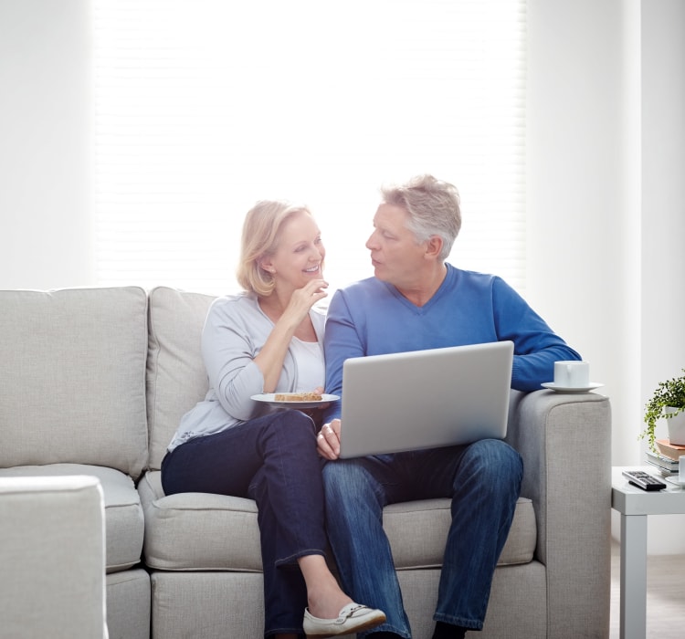 Couple enjoying laptop time at Waterway Court Apartments in Point Pleasant, New Jersey