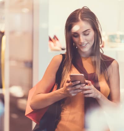 Resident checking her phone while shopping near Alterra Apartments in Las Vegas, Nevada