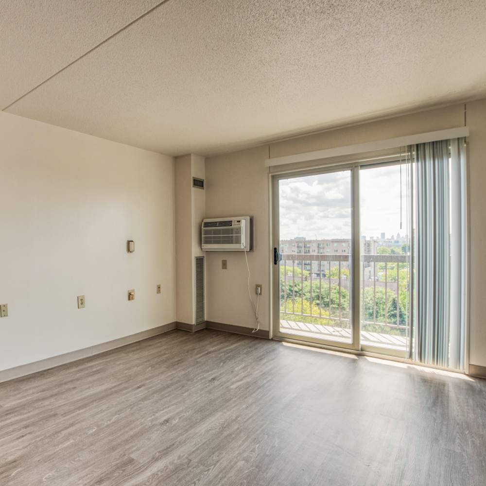 Living room with access to balcony at Village Center in Detroit, Michigan