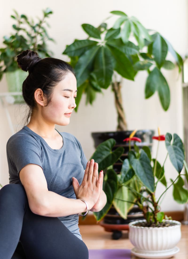 Resident doing yoga at home at Marquis at Sugarloaf in Duluth, Georgia