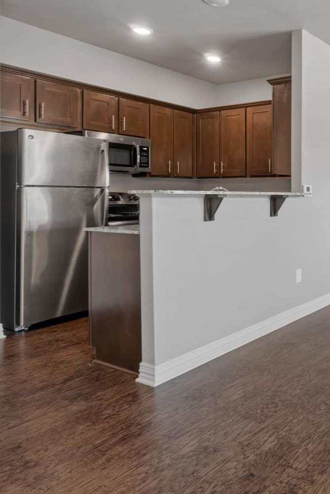 Open kitchen with upgraded appliances at Pine Creek in Paris, Texas