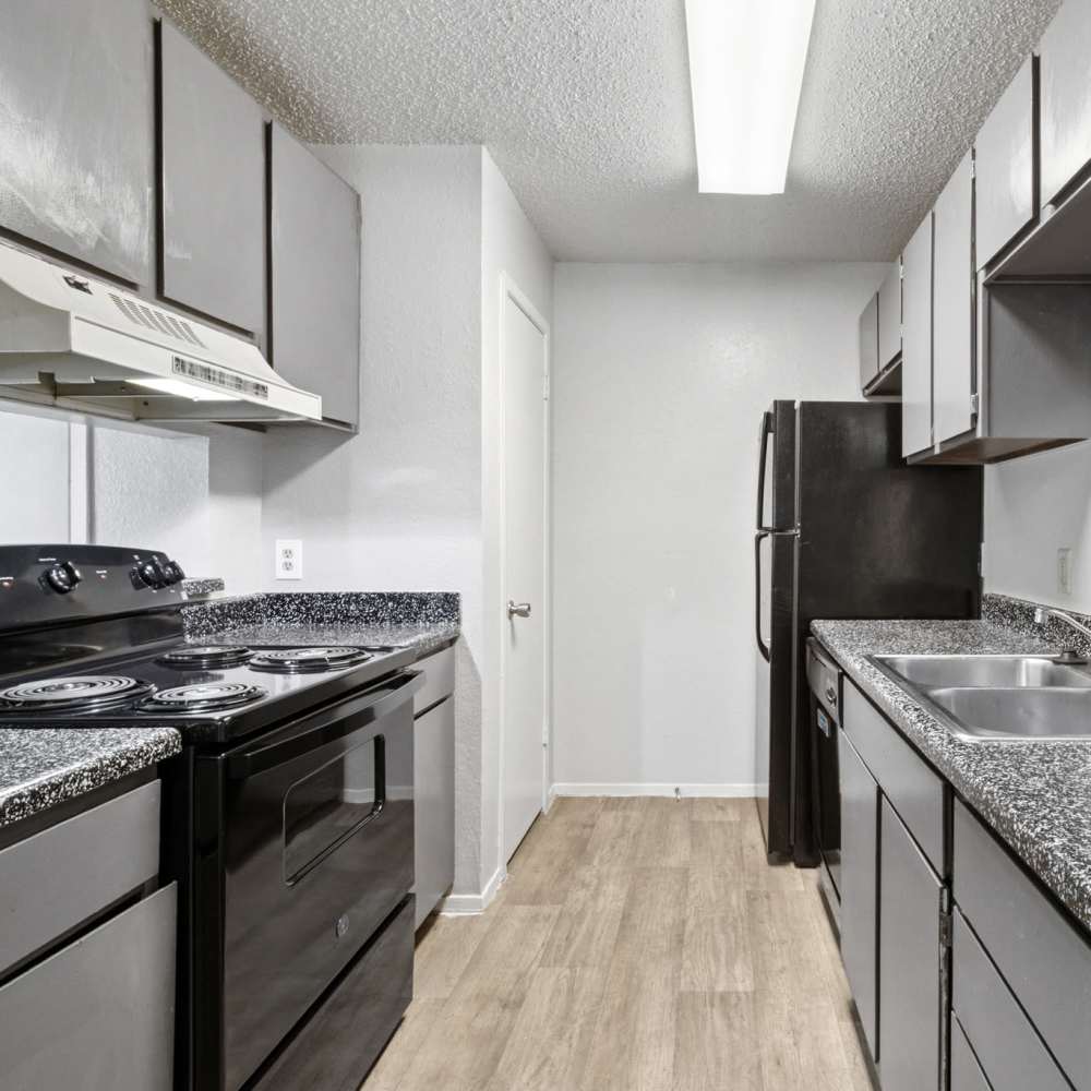 Modern kitchen with energy-efficient appliances at Arbors of Taylor in Taylor, Texas