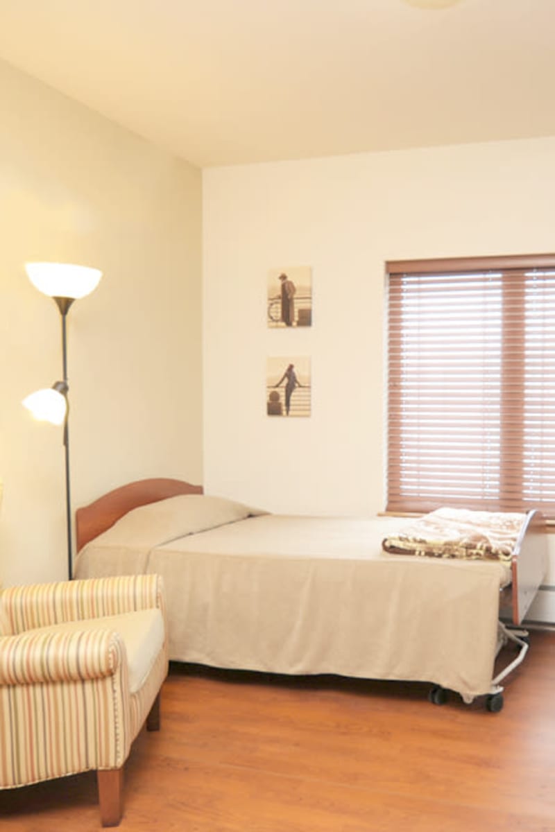 Single-resident room with a large window at Geneva Lake Manor in Lake Geneva, Wisconsin