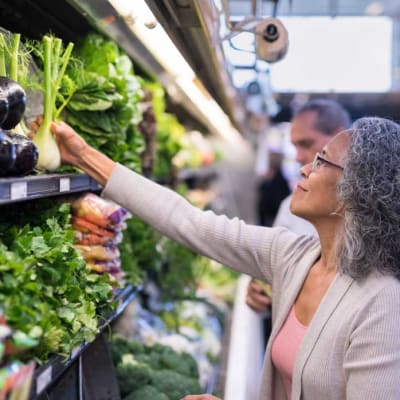 Woman shopping for fresh produce near The Towne at Northgate Apartments in Colorado Springs, Colorado