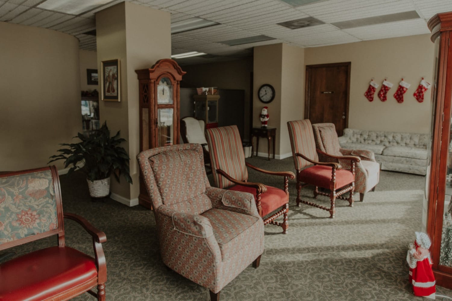 Resident reading room with multiple armchairs at The Whitcomb Senior Living Tower in St. Joseph, Michigan