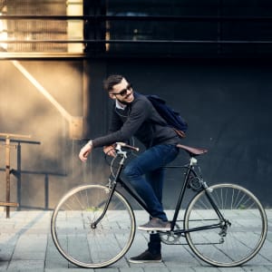 Resident biking in town near K Street Flats Apartment Homes in Berkeley, California