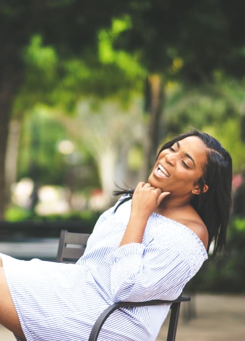 Resident sitting on a bench near The Hills at Oakwood Apartment Homes in Chattanooga, Tennessee