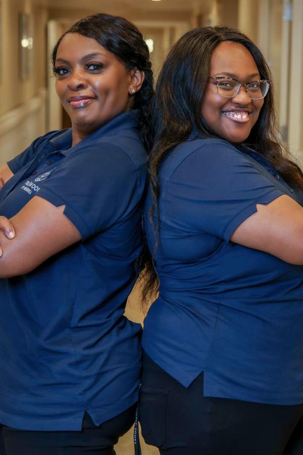 Two team members smiling at Merrill Gardens in Seattle, Washington