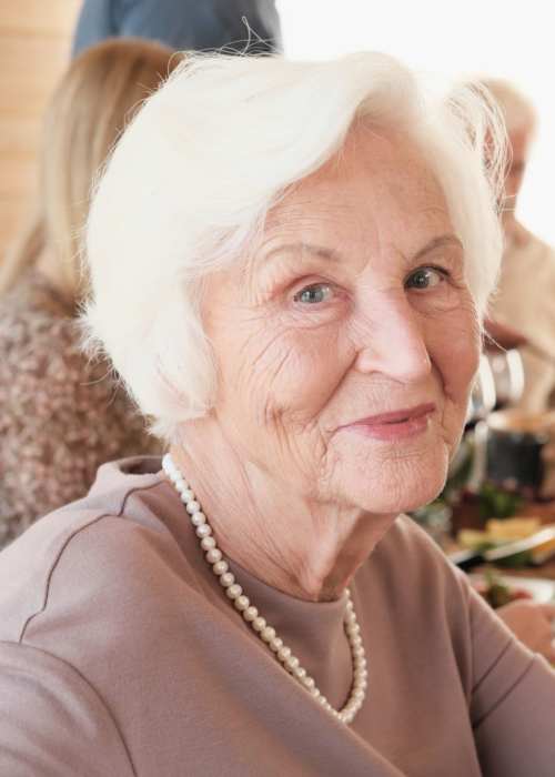 Happy resident having meal at Grand Villa of Port Charlotte in Port Charlotte, Florida
