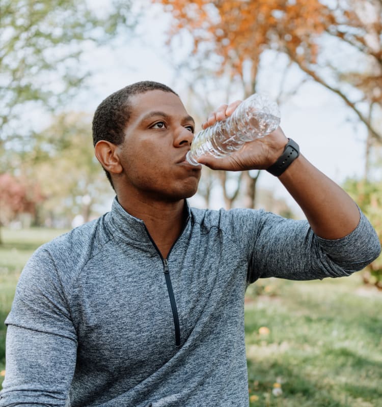 Resident hydrating after a workout in the park near Bull Run Apartments in Miami Lakes, Florida