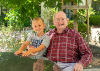 Happy resident with grandson at senior living in Campbell