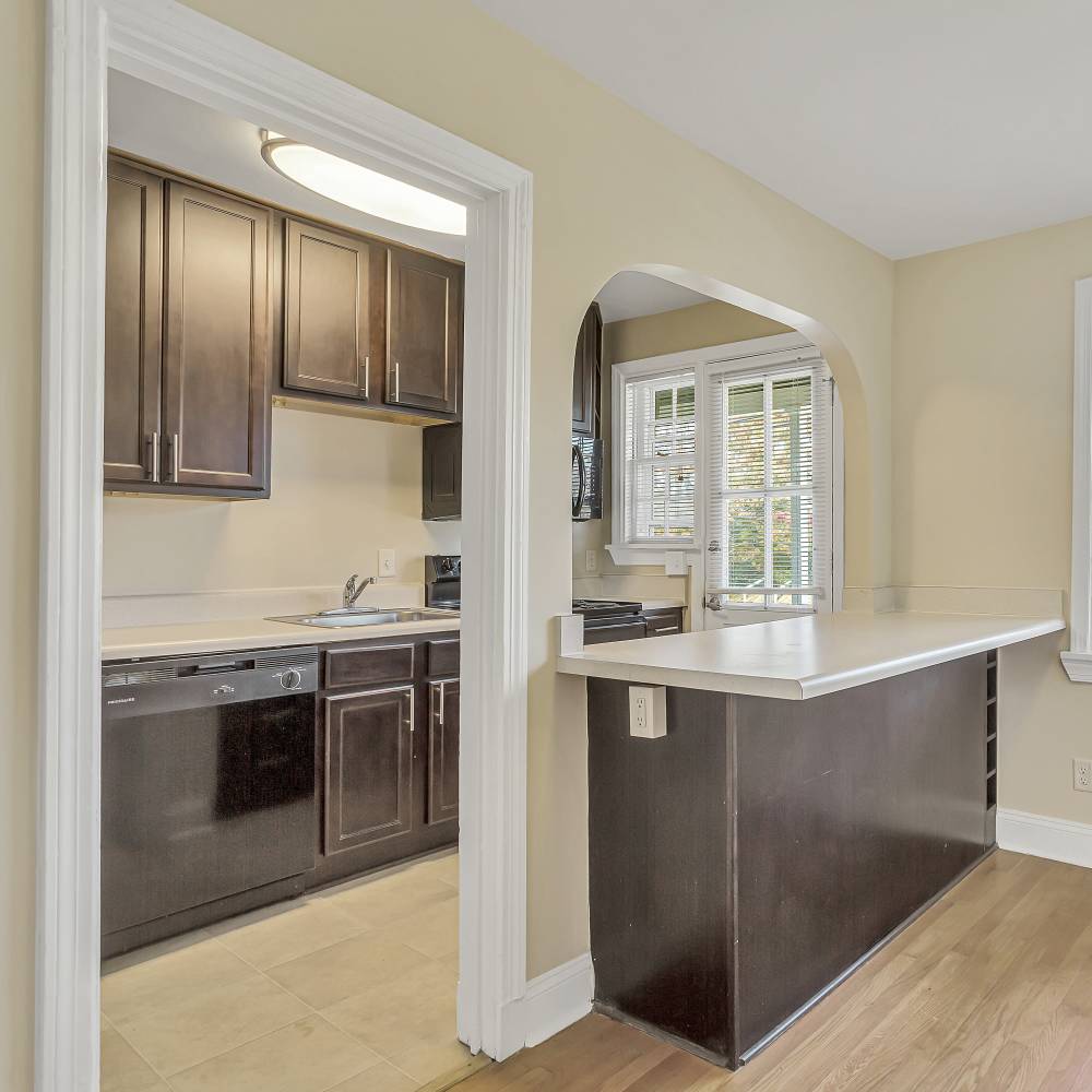 Sleek wooden cabinetry and countertops in the modern kitchen at Terraces at Bellevue in Richmond, Virginia