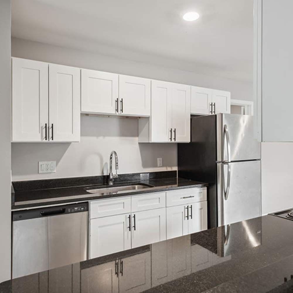 Modern kitchen with granite countertops at 83 West Townhomes in West Bloomfield Township, Michigan