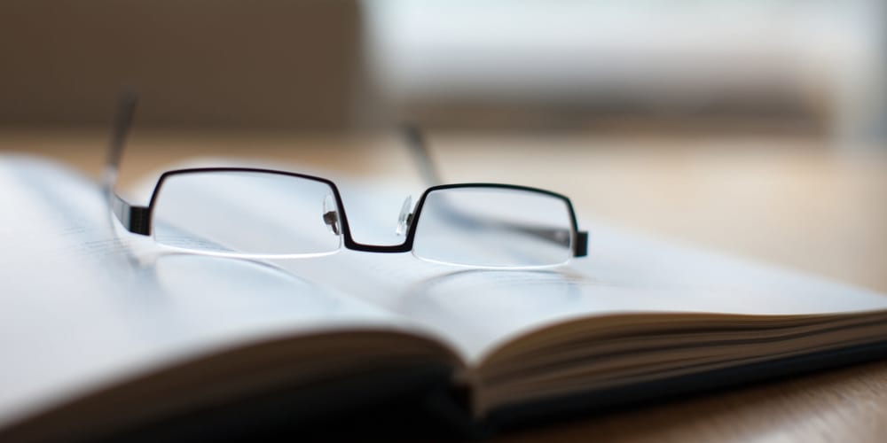 Reading glasses sitting on a book at The Springs at Lake Oswego in Lake Oswego, Oregon