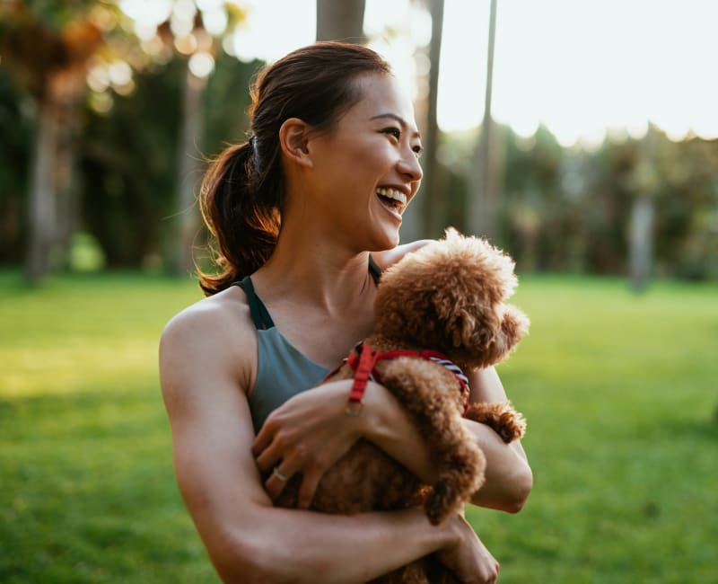 Resident with her dog in a park near The Canterbury in Columbus, Ohio