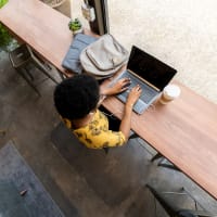 A woman sitting at a long desk using her laptop at Brighton Park in Byron, Georgia at Brighton Park in Byron, Georgia