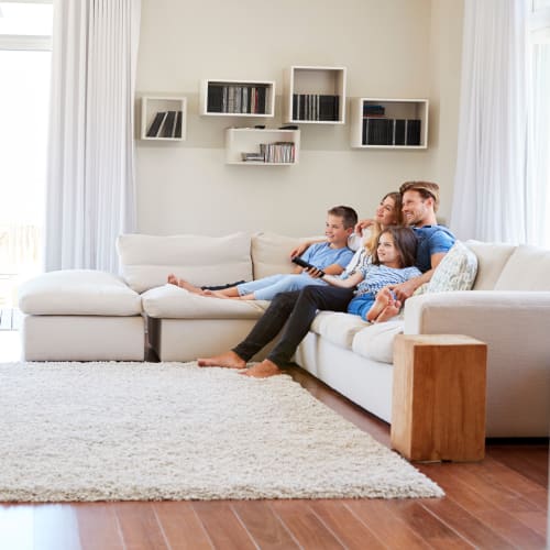 A happy family setting in living room at South Mesa I in Oceanside, California