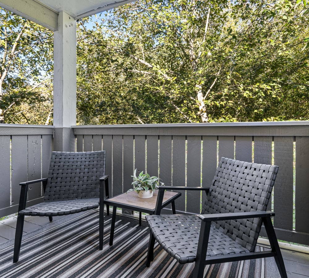 Comfortable patio overlooking the trees at Haven at Golf Creek in Portland, Oregon