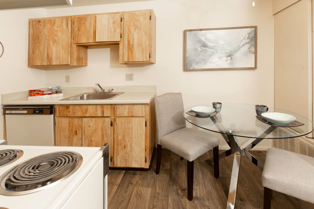 Dining room with wood-style flooring at Callaway Apartments in Taylorsville, Utah