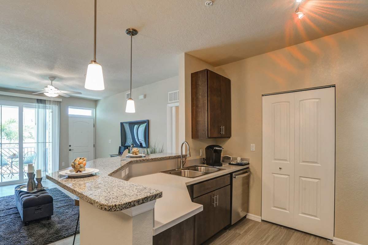 Woman putting laundry in the washer at Lemon Bay Apartments in Englewood, Florida