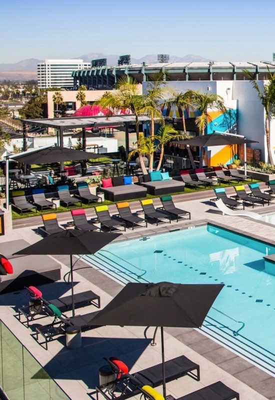 Sparkling pool with pool deck at The George Apartment Homes in Anaheim, California