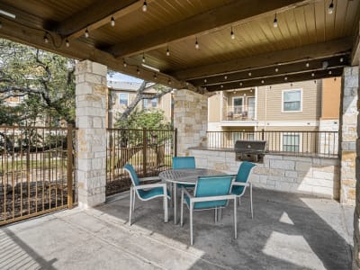Barbecue area by pool at The Residences at Panther Hollow in Marble Falls, Texas
