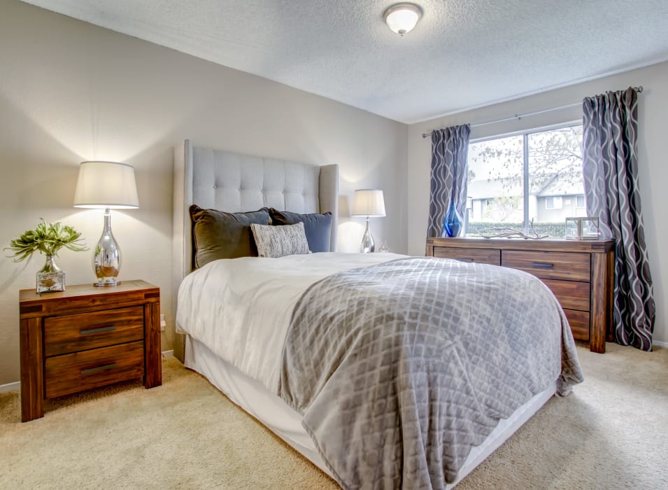 Well-furnished bedroom with plush carpeting in a model home at Vue Fremont in Fremont, California