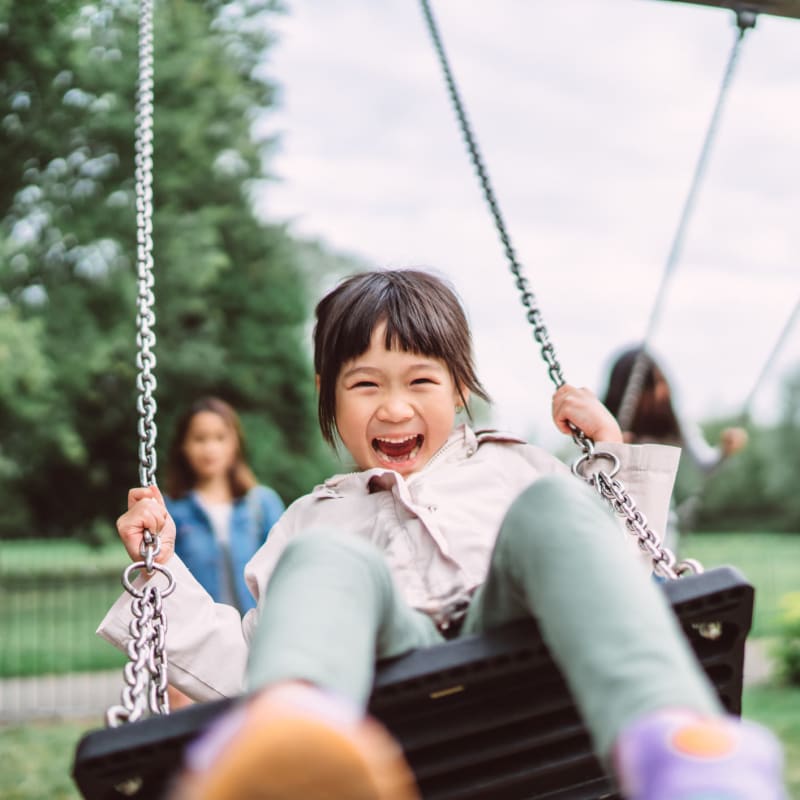 Child on a swing at Village Square Apartments in Norfolk, Virginia