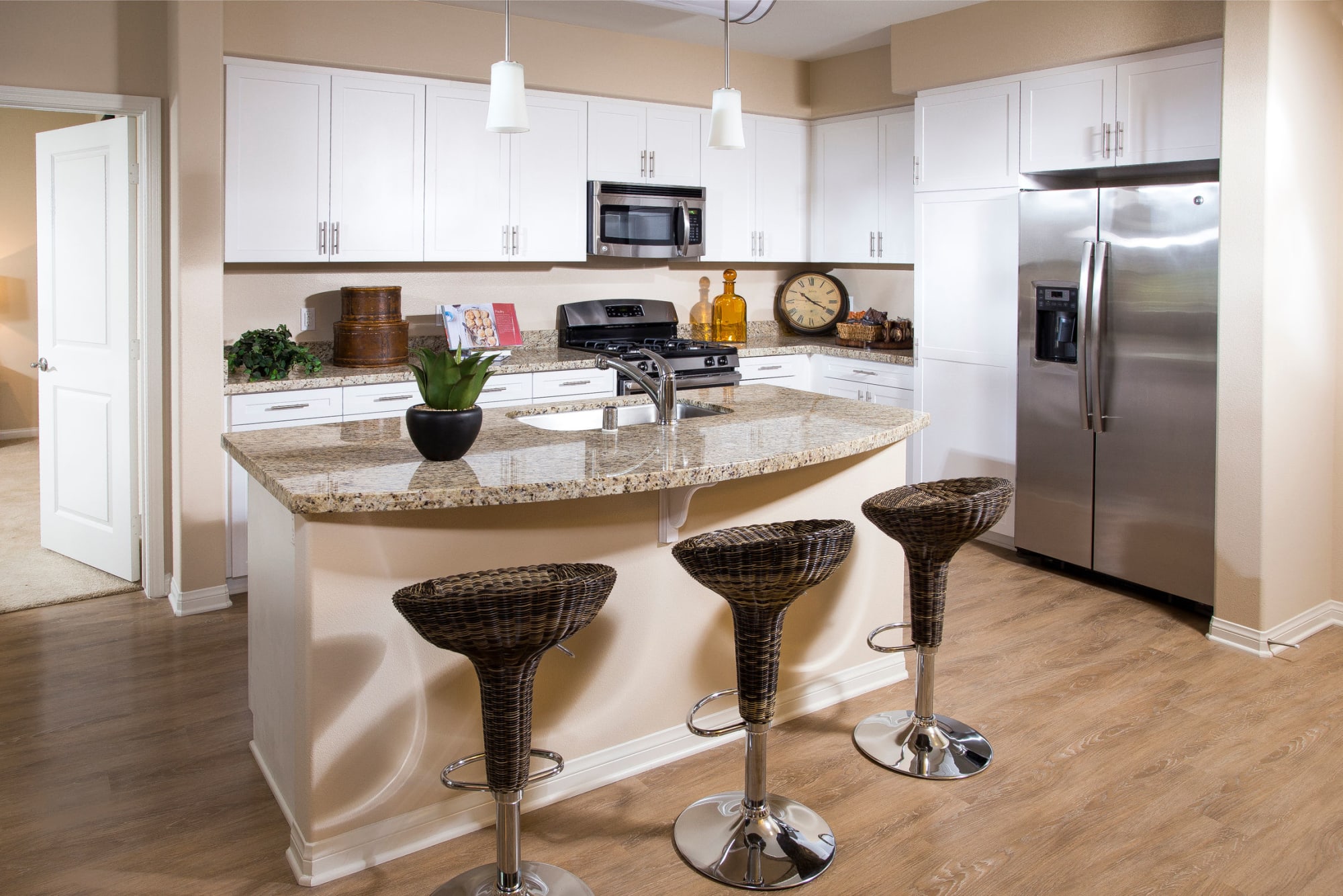 Bar seating at a kitchen island at Palisades Sierra Del Oro in Corona, California