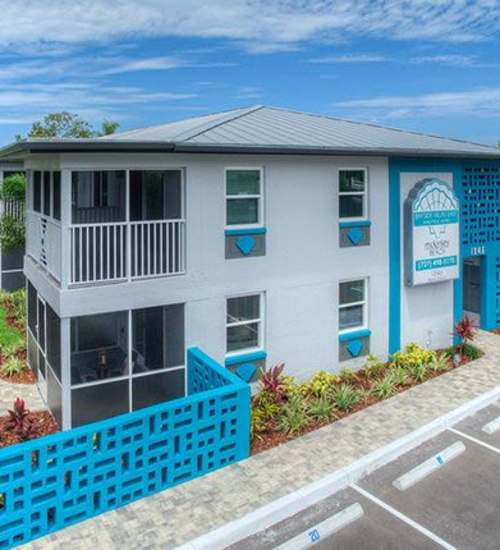 Community apartment building exterior view with signage  at Bayside Villa Apartments in South Pasadena, Florida  