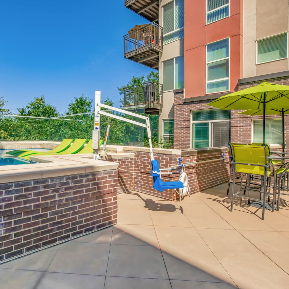Seating area near to pool at Park Place Olde Town Apartments in Arvada, Colorado