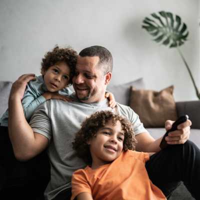 Man sitting with their kids at Lemon Bay Apartments in Englewood, Florida