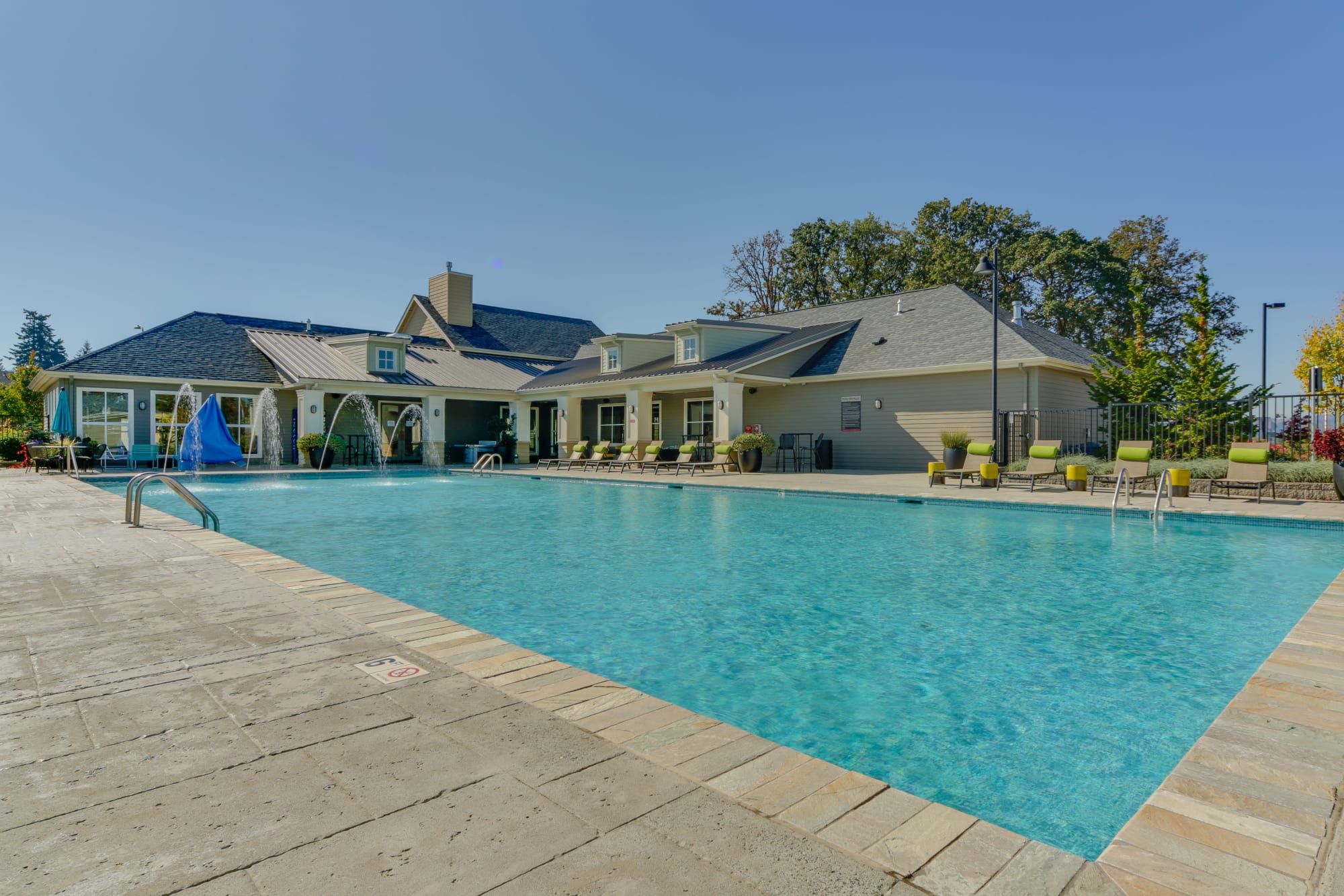 The large, sparkling swimming pool and clubhouse at Terrene at the Grove in Wilsonville, Oregon