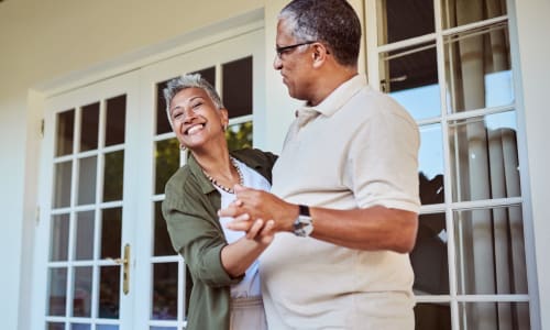 Resident couple dancing outside on the porch at Barclay House of Aiken in Aiken, South Carolina