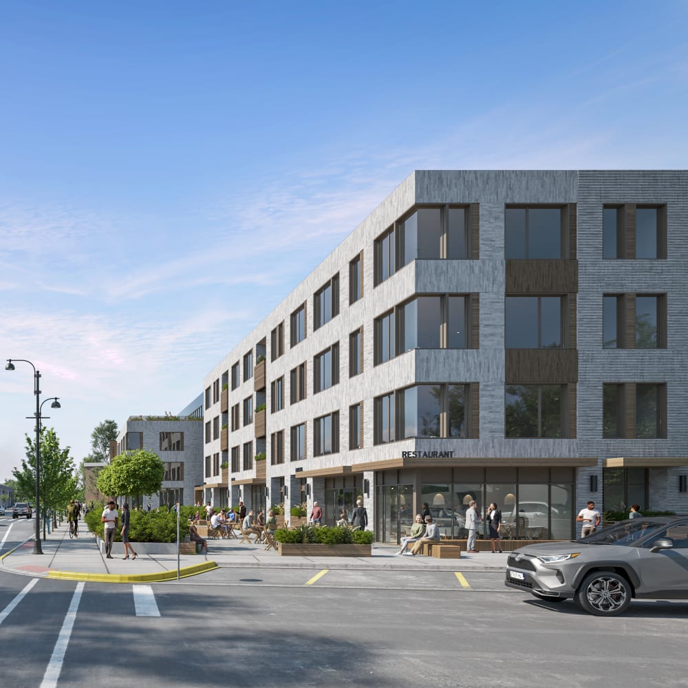 Modern apartment building with vibrant outdoor seating and greenery at Bellwood Gateway Apartments in Bellwood, Illinois