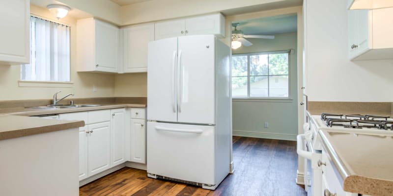 A kitchen with a refrigerator in a home at O'Neill Heights in Oceanside, California