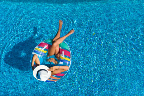 Woman lounging in the pool by Berkshire Laurel Creek, Fairfield, California